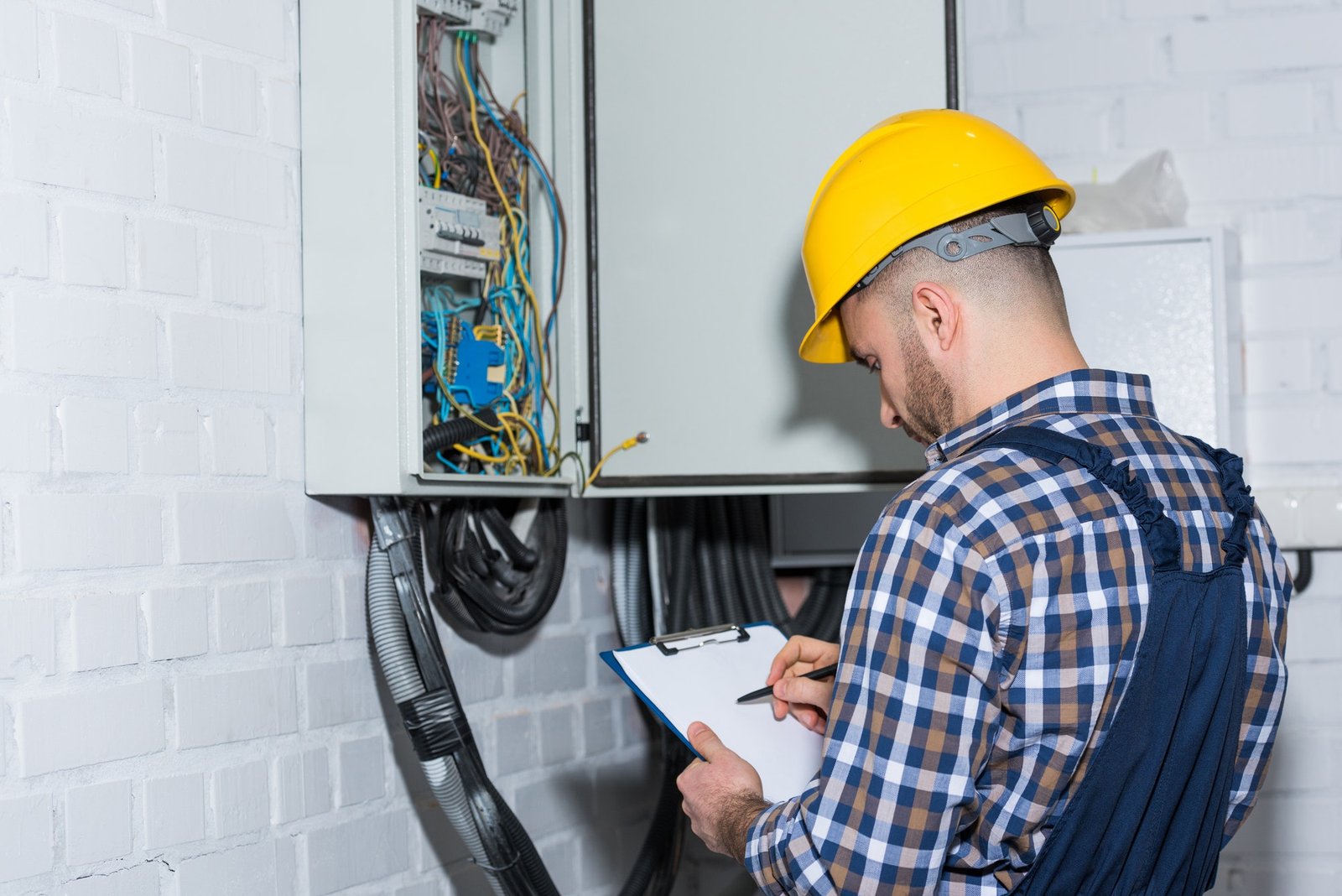professional-electrician-inspecting-wires-in-electrical-box.jpg